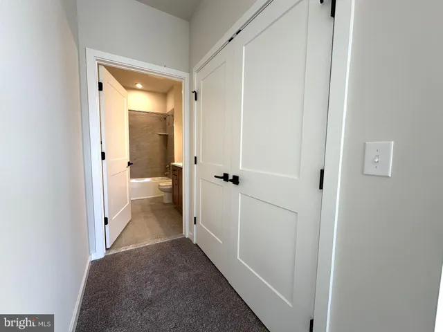 a view of a bathroom from a hallway