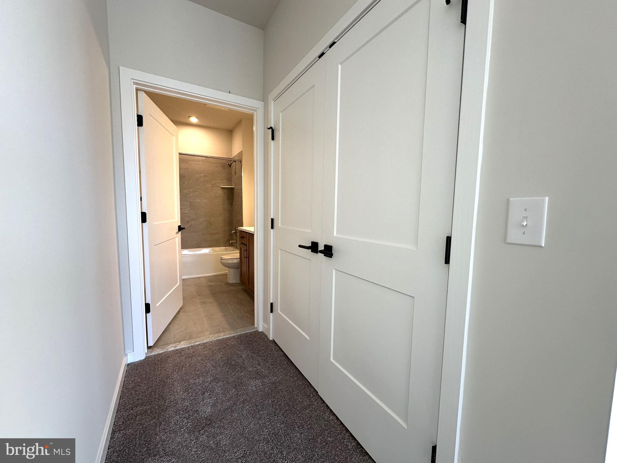 409 West Butler Avenue, Unit 223 Chalfont, PA 18914 - Photo 16 of 33 a view of a bathroom from a hallway