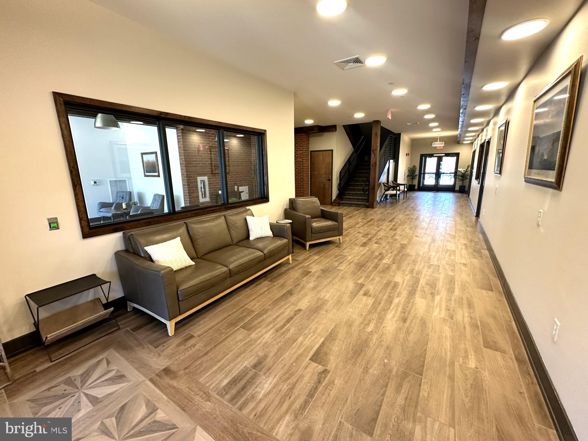 409 West Butler Avenue, Unit 223 Chalfont, PA 18914 - Photo 2 of 33 a living room with furniture and a wooden floor