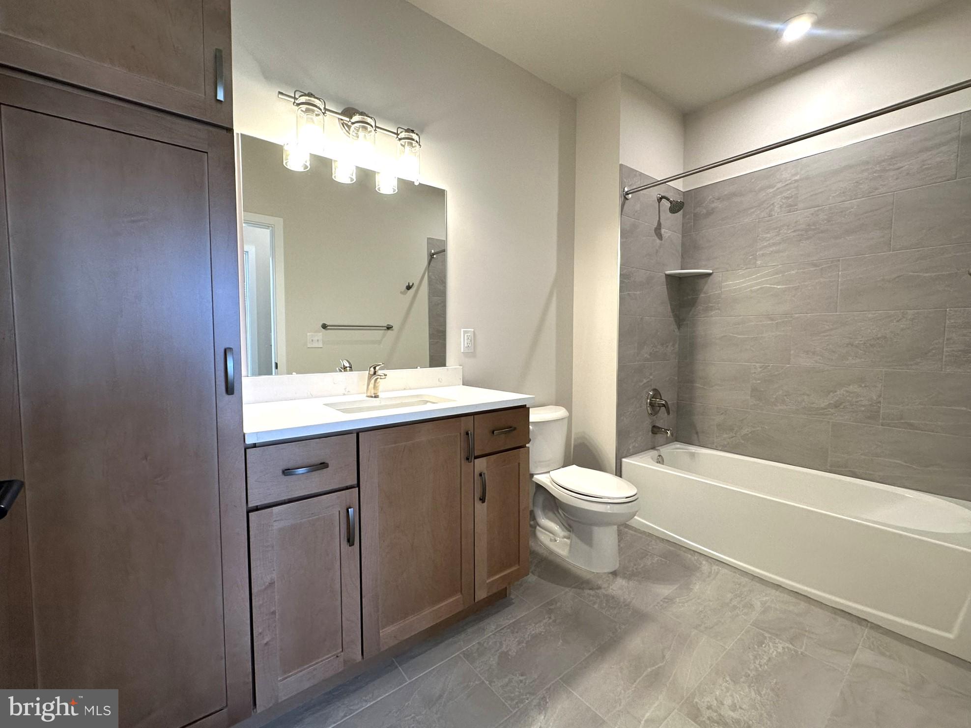 409 West Butler Avenue, Unit 223 Chalfont, PA 18914 - Photo 22 of 33 a bathroom with a double vanity sink toilet and shower