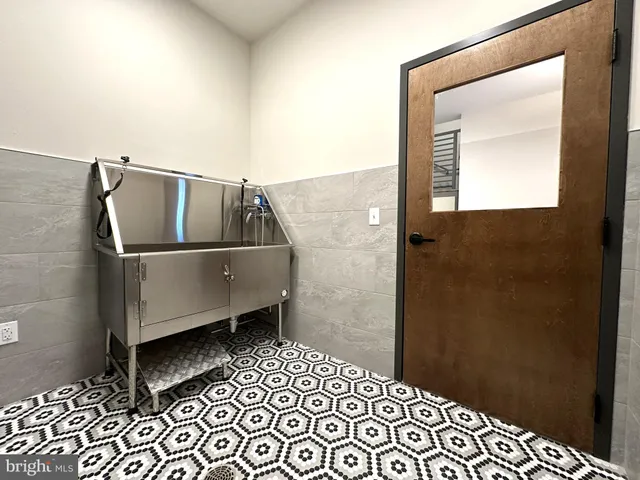 a room with a wooden floor and a sink