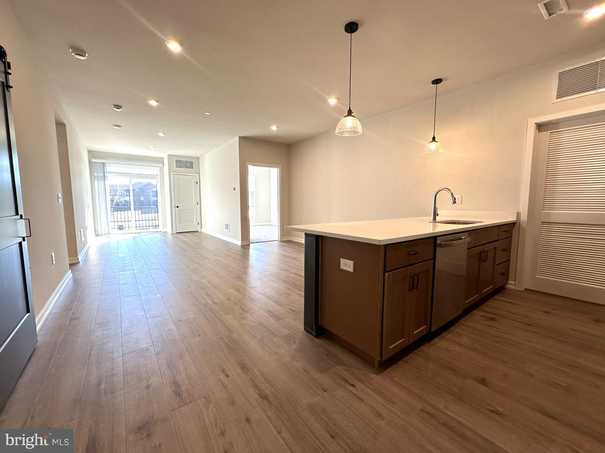 409 West Butler Avenue, Unit 223 Chalfont, PA 18914 - Photo 4 of 33 a kitchen with stainless steel appliances granite countertop a sink a counter space and wooden floor