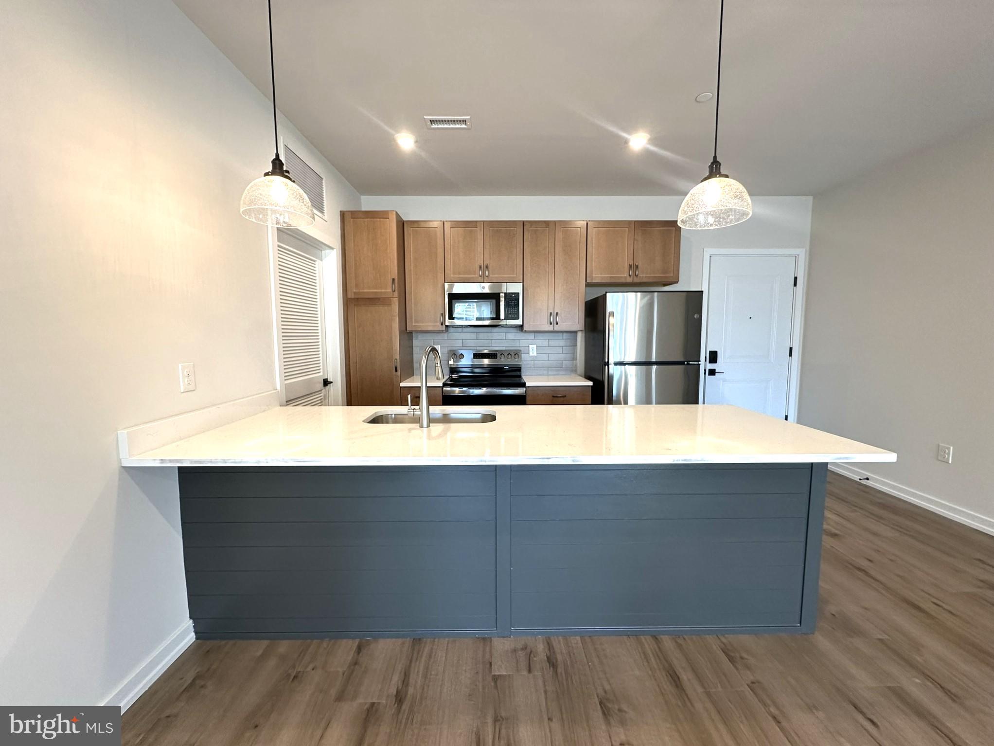 409 West Butler Avenue, Unit 223 Chalfont, PA 18914 - Photo 6 of 33 a kitchen with kitchen island a sink stainless steel appliances and cabinets