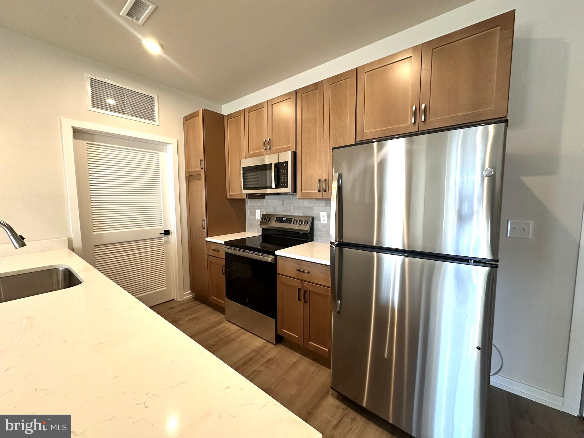 409 West Butler Avenue, Unit 223 Chalfont, PA 18914 - Photo 7 of 33 a kitchen with stainless steel appliances a refrigerator sink and cabinets