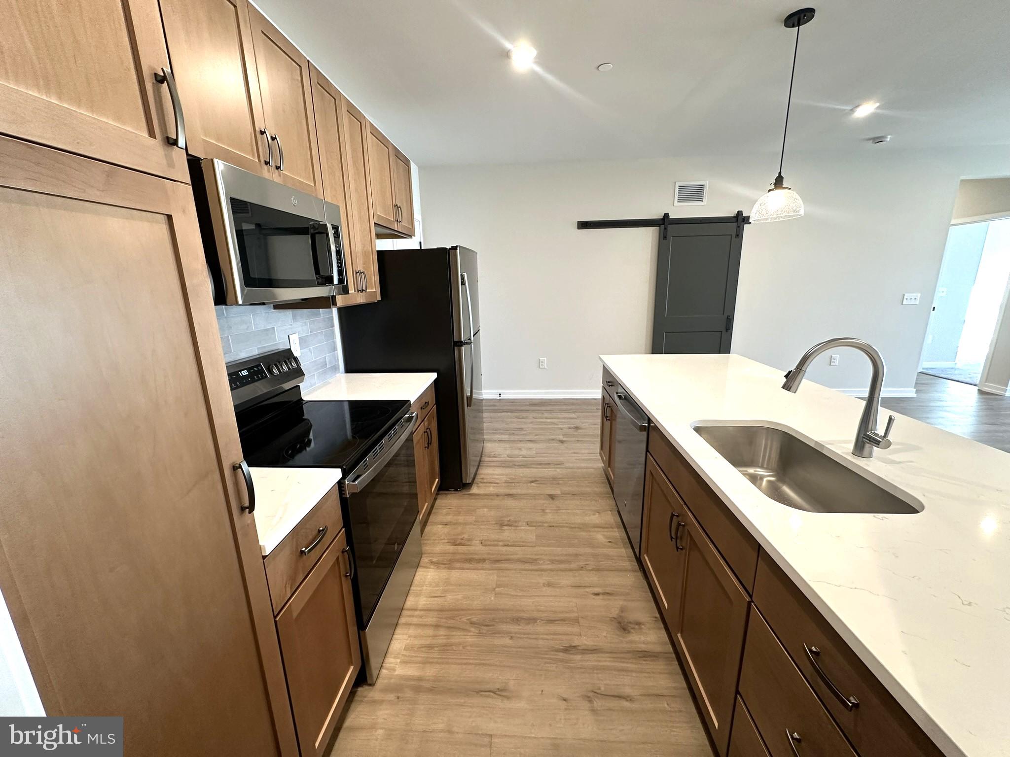 409 West Butler Avenue, Unit 223 Chalfont, PA 18914 - Photo 8 of 33 a kitchen with stainless steel appliances a sink stove and refrigerator