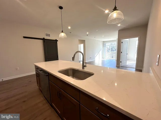 a kitchen with stainless steel appliances a sink and a refrigerator