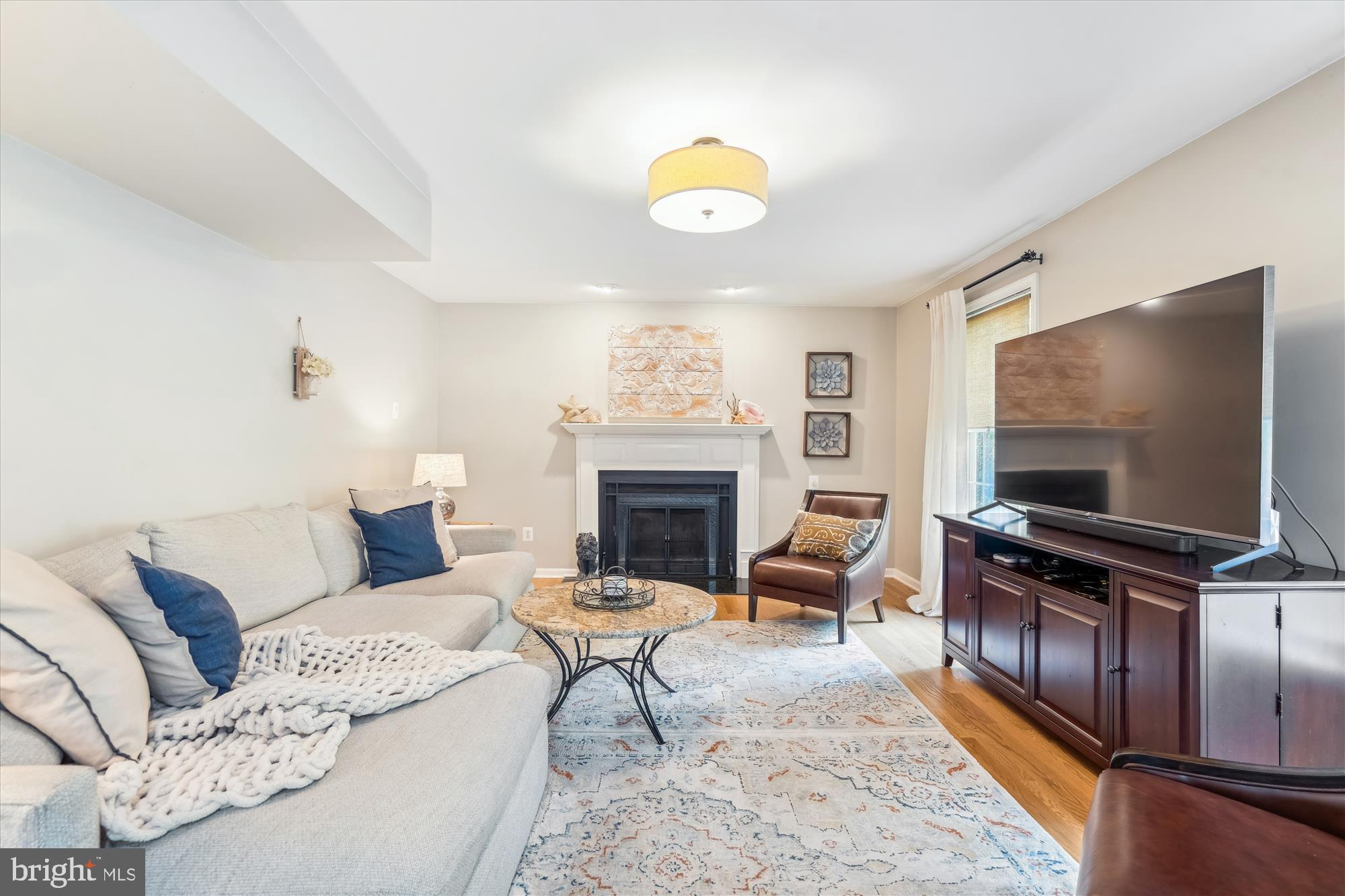 1043 Skyview Drive Annapolis, MD 21409 - Photo 16 of 71 a living room with furniture a fireplace and a flat screen tv