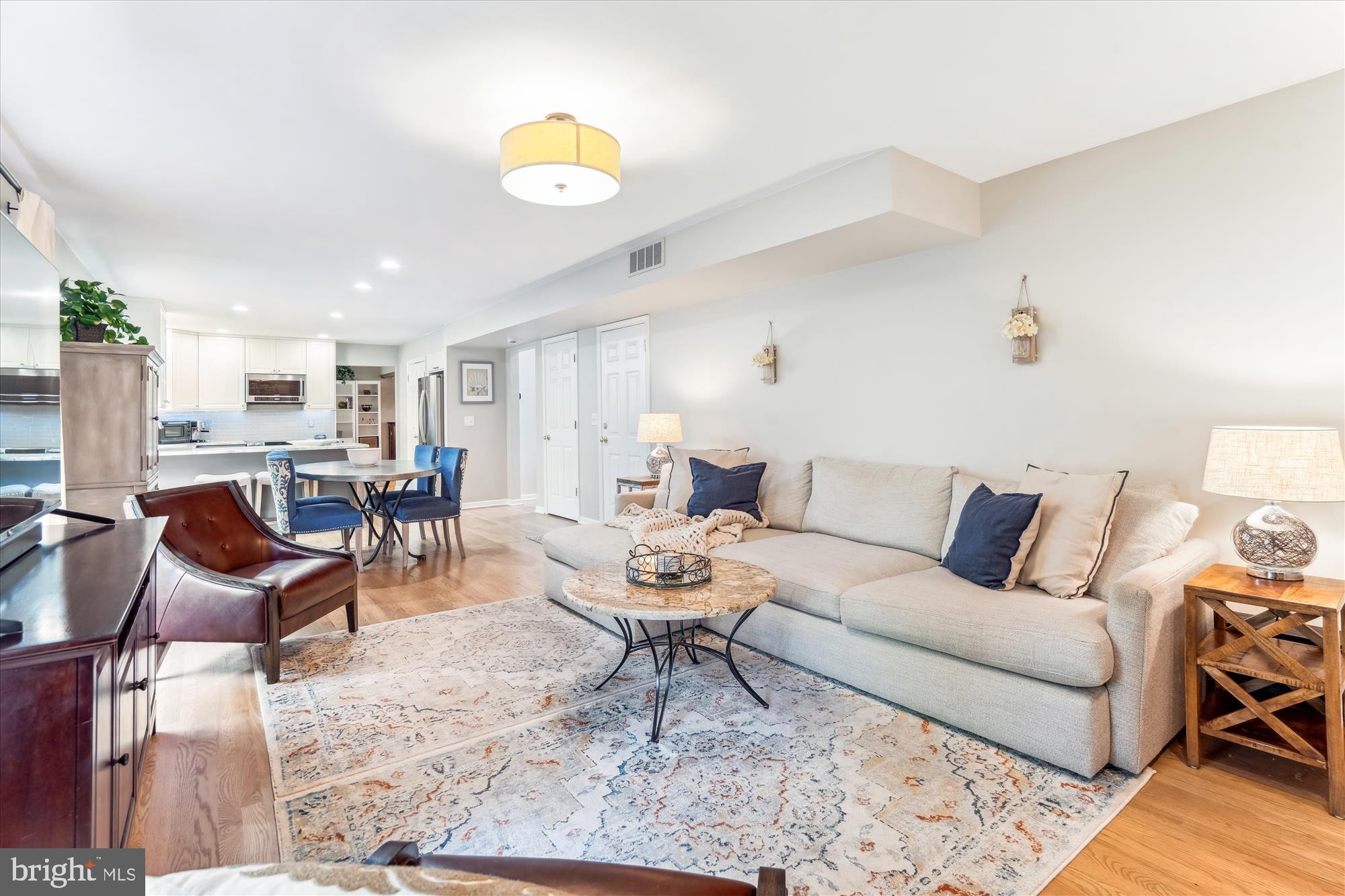 1043 Skyview Drive Annapolis, MD 21409 - Photo 18 of 71 a living room with furniture and a dining table with wooden floor