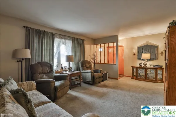 a living room with furniture chandelier and a chandelier