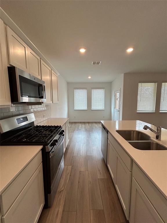 213 Post Oak Street Azle, TX 76020 - Photo 14 of 24 a kitchen with a sink stove and microwave
