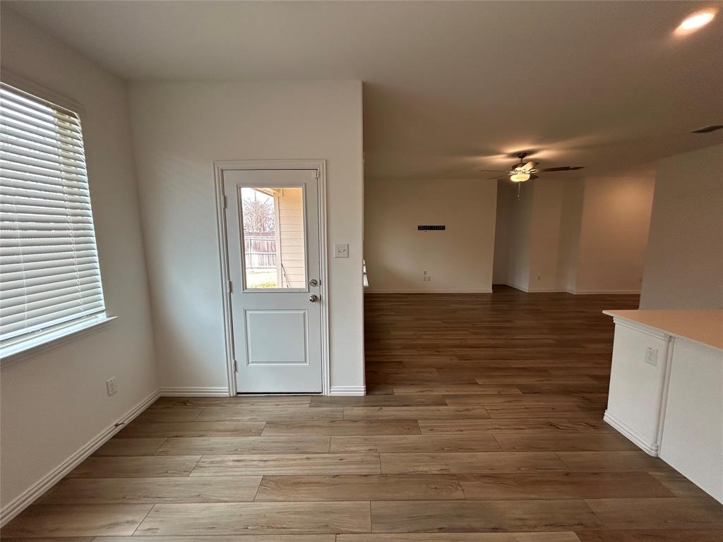 213 Post Oak Street Azle, TX 76020 - Photo 17 of 24 wooden floor in an empty room with a window