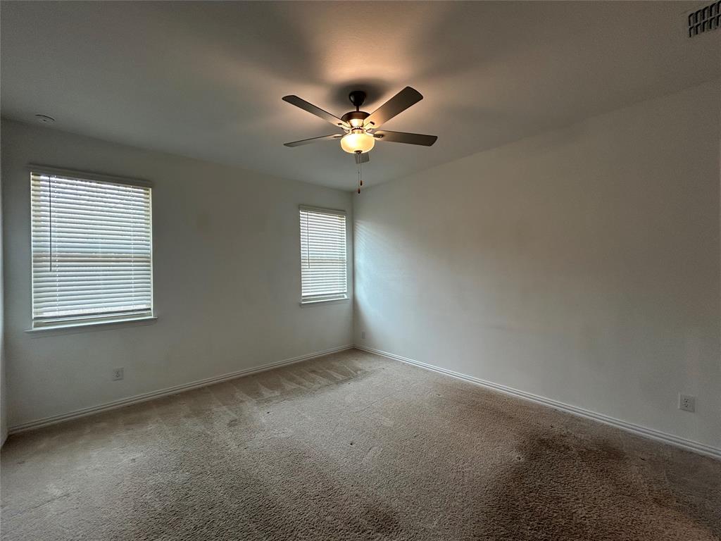 213 Post Oak Street Azle, TX 76020 - Photo 18 of 24 an empty room with windows and fan