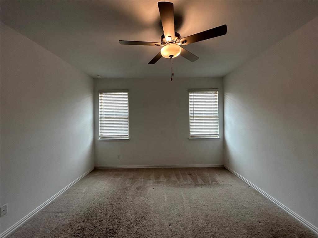213 Post Oak Street Azle, TX 76020 - Photo 19 of 24 an empty room with windows and fan