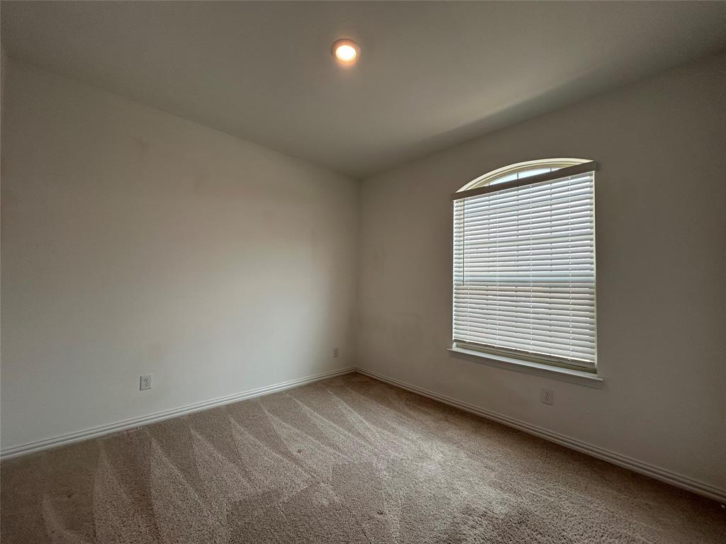 213 Post Oak Street Azle, TX 76020 - Photo 5 of 24 an empty room with a window