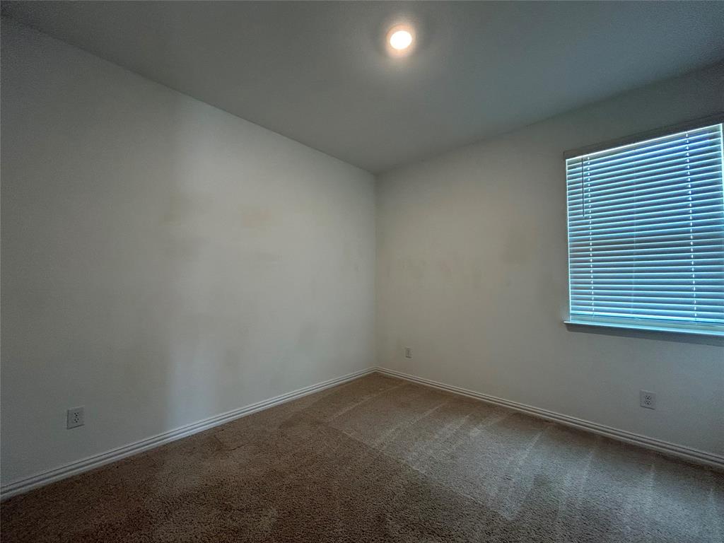 213 Post Oak Street Azle, TX 76020 - Photo 7 of 24 an empty room with a window
