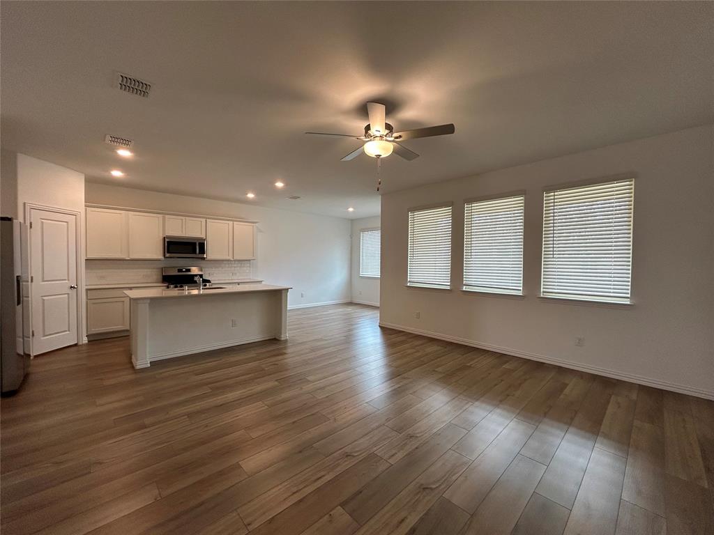 213 Post Oak Street Azle, TX 76020 - Photo 9 of 24 a view of kitchen with granite countertop stainless steel appliances sink and wooden floor
