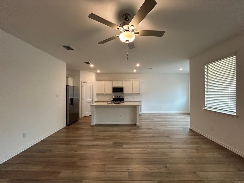 213 Post Oak Street Azle, TX 76020 - Photo 10 of 24 a view of kitchen with cabinets microwave and stove top oven