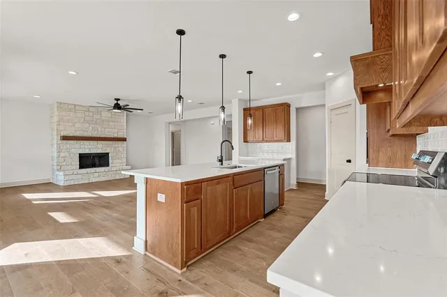 a large white kitchen with stainless steel appliances