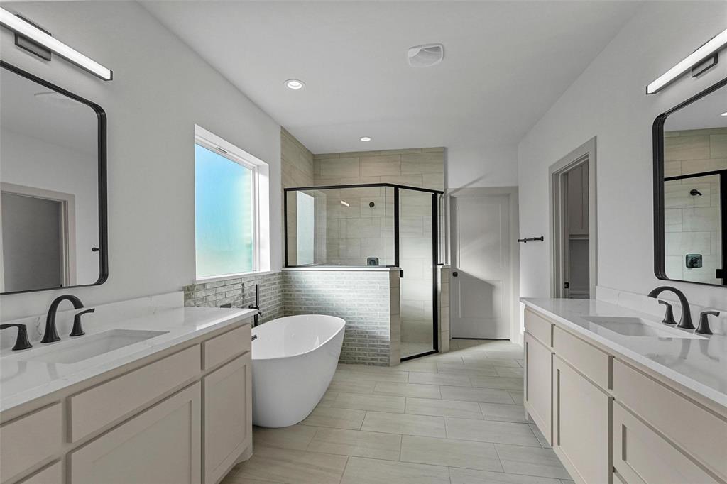 730 Evergreen Nevada, TX 75173 - Photo 22 of 40 a spacious bathroom with a double vanity sink double mirror and a bathtub
