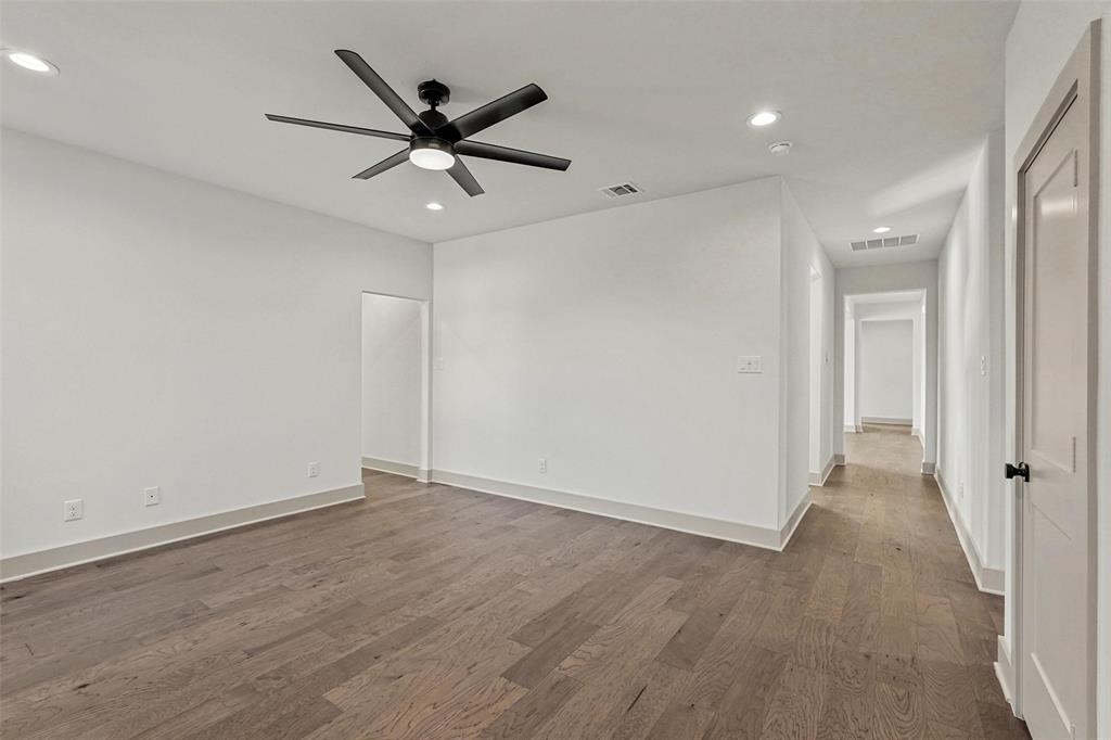 730 Evergreen Nevada, TX 75173 - Photo 26 of 40 wooden floor in an empty room with a ceiling fan