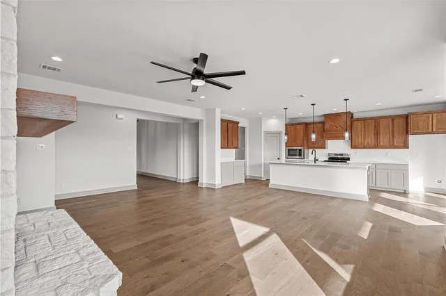 a view of kitchen with cabinets and wooden floor