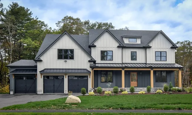 a front view of a house with garden and plants