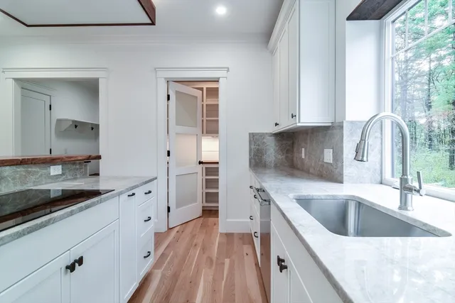 a view of a kitchen with a oven and cabinets