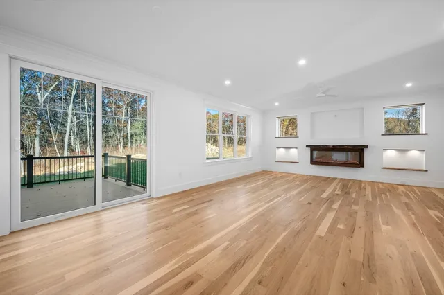 a living room with furniture a flat screen tv and a window