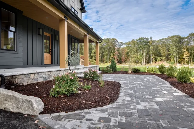 a front view of a house with garden