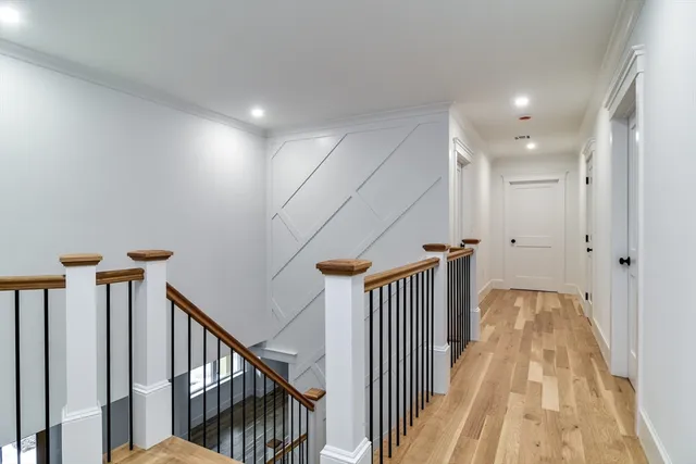 a bedroom with a large bed and wooden floor
