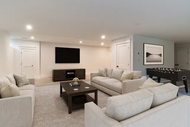 a front view of a house with a garden and trees