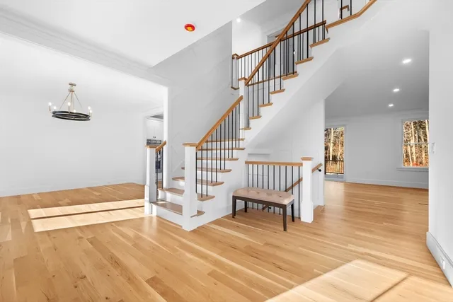 a view of entryway and hall with wooden floor