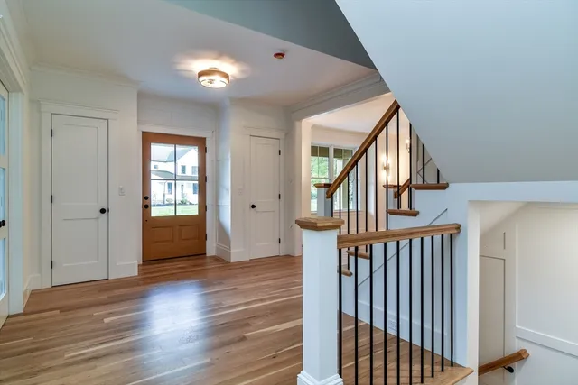a view of entryway with wooden floor and stairs