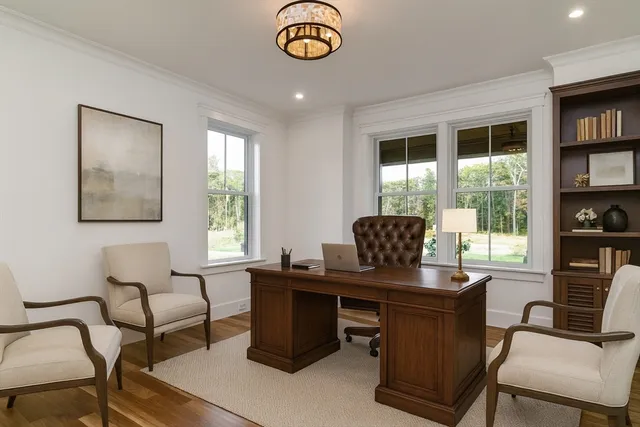 a view of a workspace with furniture and a window