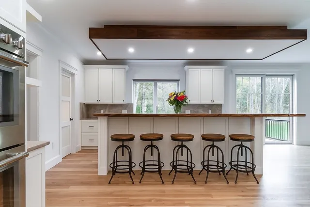 a dinning room with furniture and wooden floor