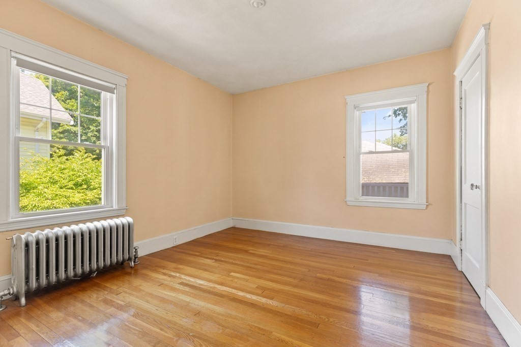 24 Fairbanks Road Milton, MA 02186 - Photo 16 of 19 a view of an empty room with wooden floor and a window