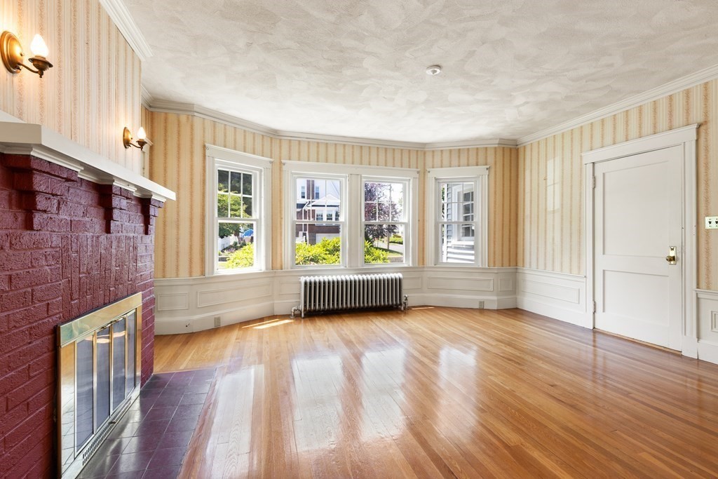 24 Fairbanks Road Milton, MA 02186 - Photo 2 of 19 a view of an empty room with glass door and wooden floor