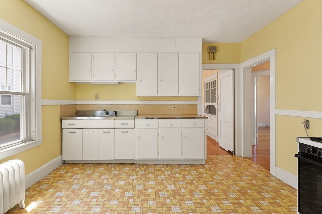 24 Fairbanks Road Milton, MA 02186 - Photo 5 of 19 a view of kitchen with granite countertop white cabinets and refrigerator