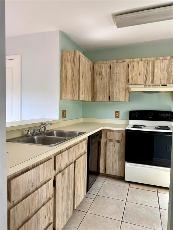6264 Southwest 8th Place Gainesville, FL 32607 - Photo 4 of 22 a kitchen with a sink and a stove top oven