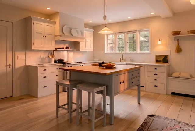 a kitchen with a table chairs refrigerator and cabinets