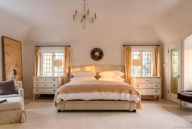 a spacious bedroom with a bed and window