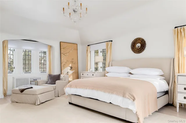 a bedroom with a large bed and a window