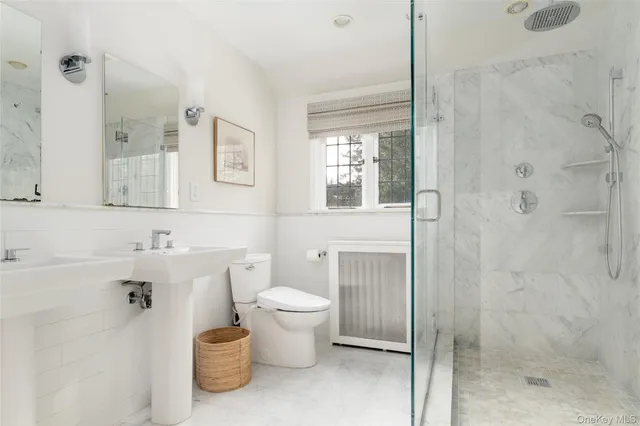 a bathroom with a toilet sink and shower