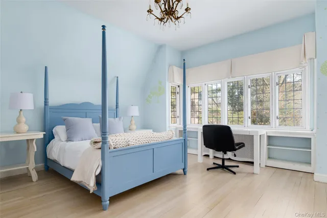 a bedroom with a bed and a desk