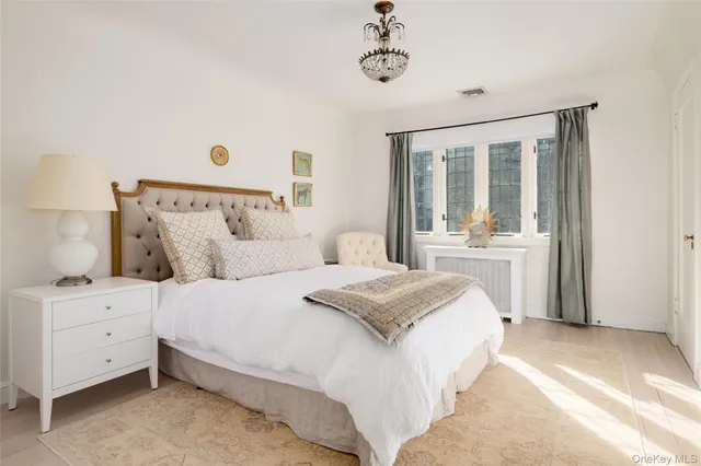 a bedroom with a large bed and a window