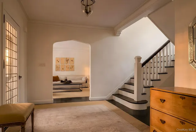 a view of entryway and hall with wooden floor