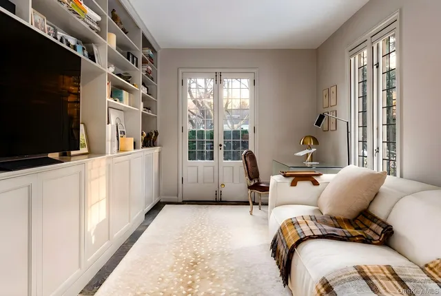 a bedroom with furniture and a flat screen tv
