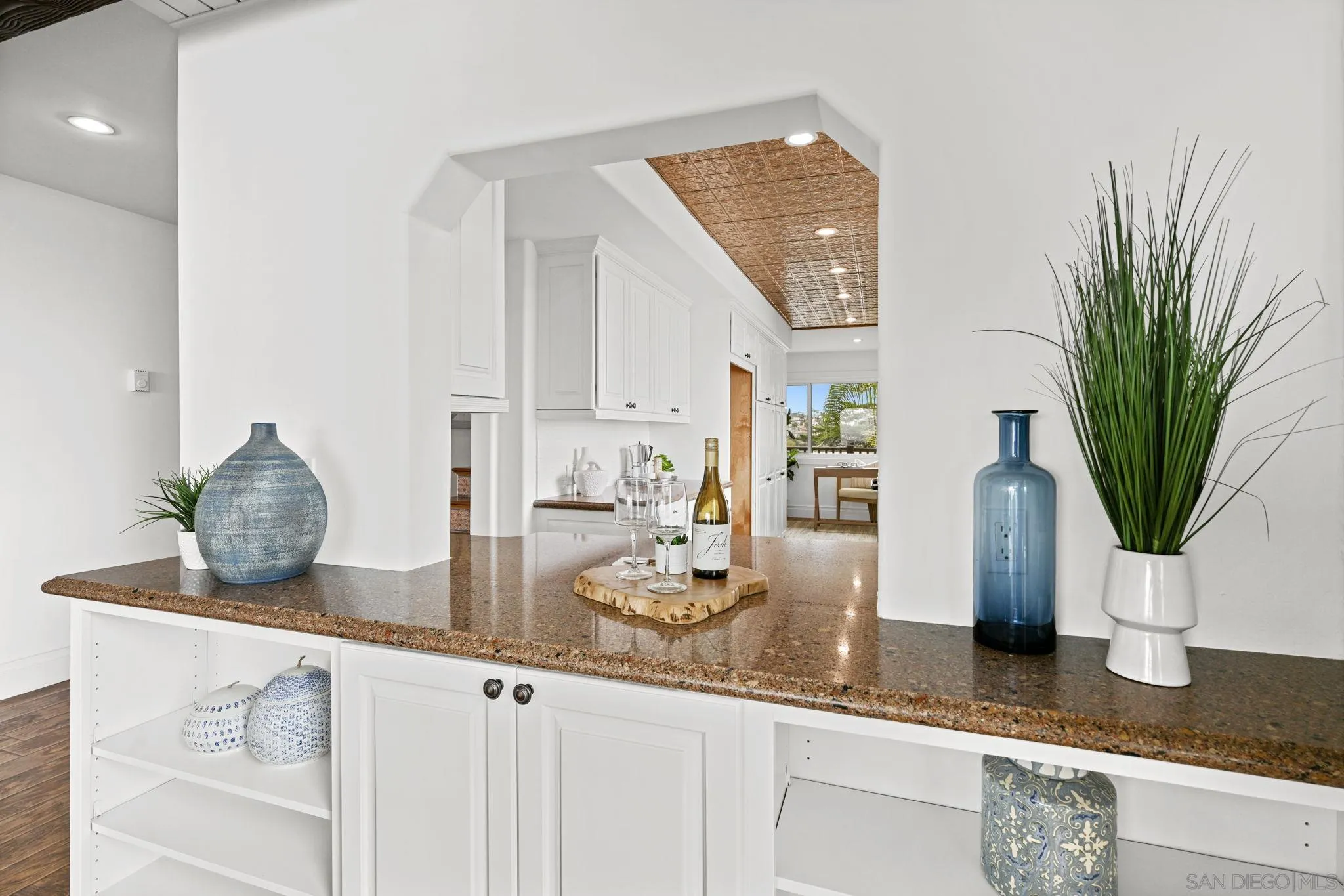 337 West I Street Encinitas, CA 92024 - Photo 16 of 58 a kitchen with granite countertop a sink and a white wooden cabinets