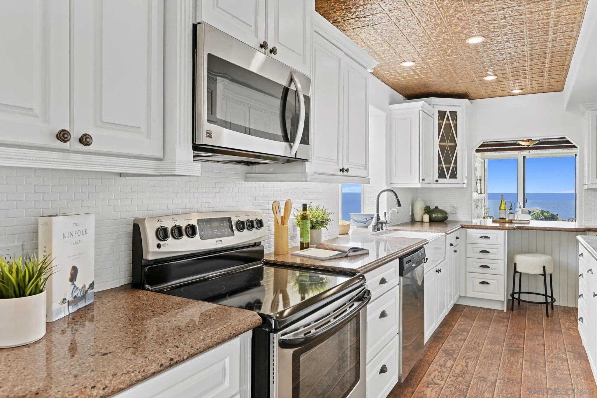 337 West I Street Encinitas, CA 92024 - Photo 21 of 58 a kitchen with stainless steel appliances granite countertop a sink stove and microwave