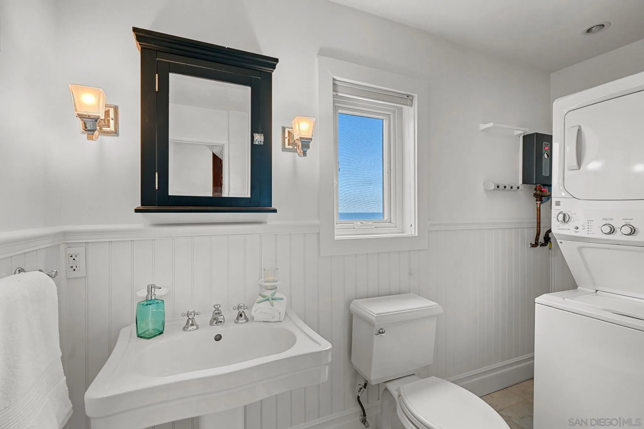 337 West I Street Encinitas, CA 92024 - Photo 24 of 58 a white toilet sitting next to a bathroom sink